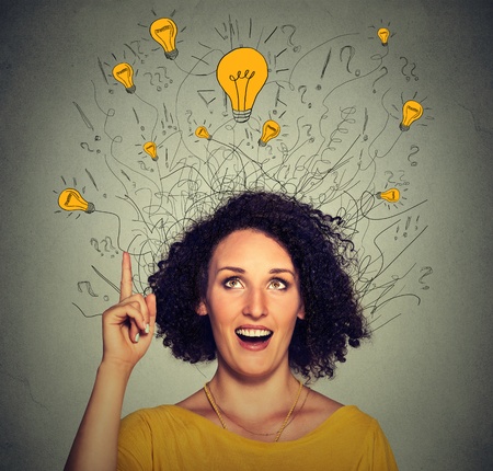 48488978 - closeup excited woman with many ideas light bulbs above head looking up pointing finger up isolated on gray wall background. eureka creativity concept